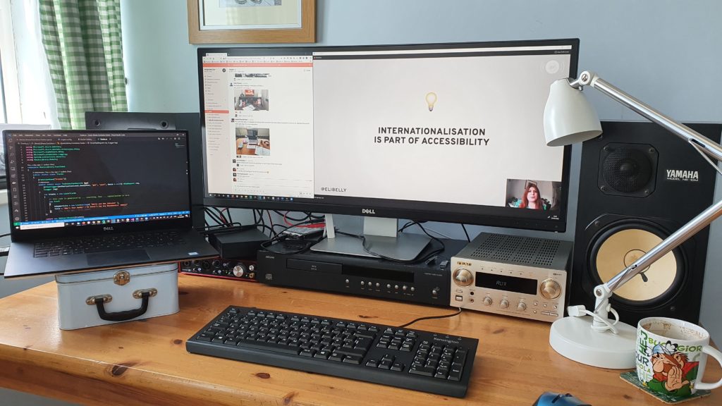 My desk with my laptop sitting on a lunchbox, which I used as a makeshift stand